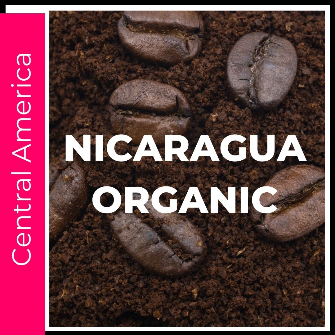 Nicaragua Organic Coffee. Light letters on top of rich brown roasted coffee. This is a title page image to click into the various size and consistency options available for this specialty grade coffee origin. This is a picture of coffee beans sitting on ground coffee on a bright hot pink colored background to denote this coffee comes from the main coffee growing region of Central America.