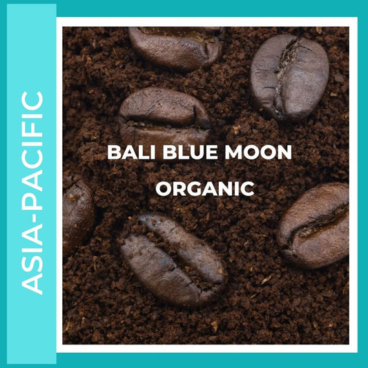 Bali Blue Moon Organic Coffee. This is a title page Image to click into the various size and consistency options available. This is a picture of coffee beans sitting on ground coffee on a sea colored background to denote it comes from the Main coffee growing region of Asia Pacific